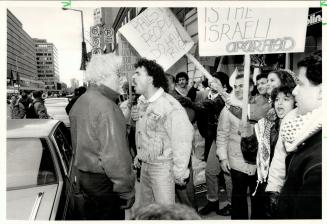 Passerby and protester exhchange heated words during downtown march yesterday by pro-Palestine Organization