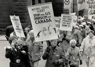 Joining forces: Peace groups, free trade protesters and environmentalists marched from Queen's Park through the downtown core yesterday