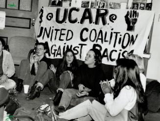 Making a point: University of Toronto students sit outside the president's office yesterday to demonstrate against what they call institutionalized racism on campus