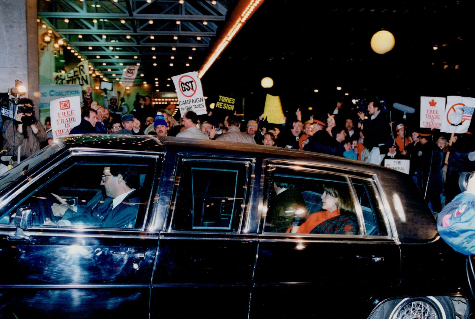 Limo fortress: Mila and Brian Mulroney are chauffeured past an angry crowd outside the Harbour Castle Westin Hotel last night as they arrive for a $500-a-plate Conservative fundraising dinner