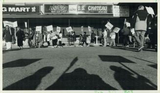 Street protest: ratepayers' Association members picket yesterday in front of Candy's, an after-hours bar in the Thistletown plaza