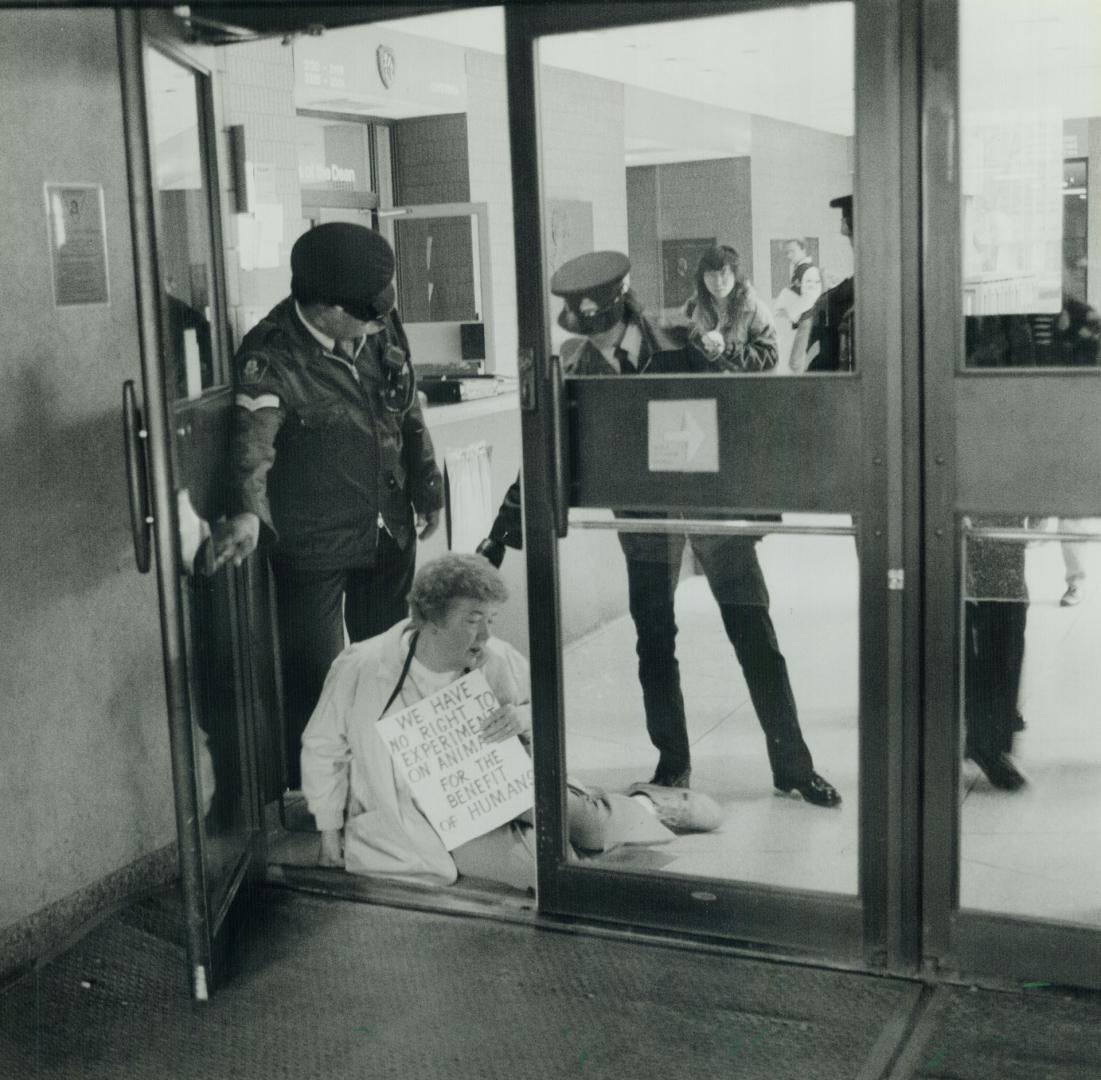 Sit-down protest: Pat Lawrence is removed from lobby U of T Medical Sciences Buildings where she protested the use of animals for medical experimentation last month