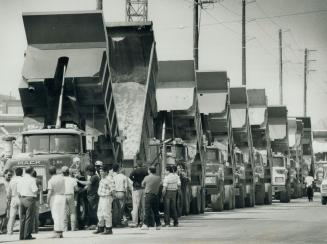 Up in arms: Dump truck drivers protesting unpaid wages yesterday block an Etobicoke site from which they hauled excavated material