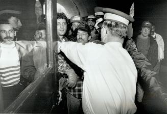 Help back: Gravel truck drivers are stopped by OPP officers yesterday as they try to break into the Legislature to protest everything from high diesel fuel taxes to a new law licensing brokers