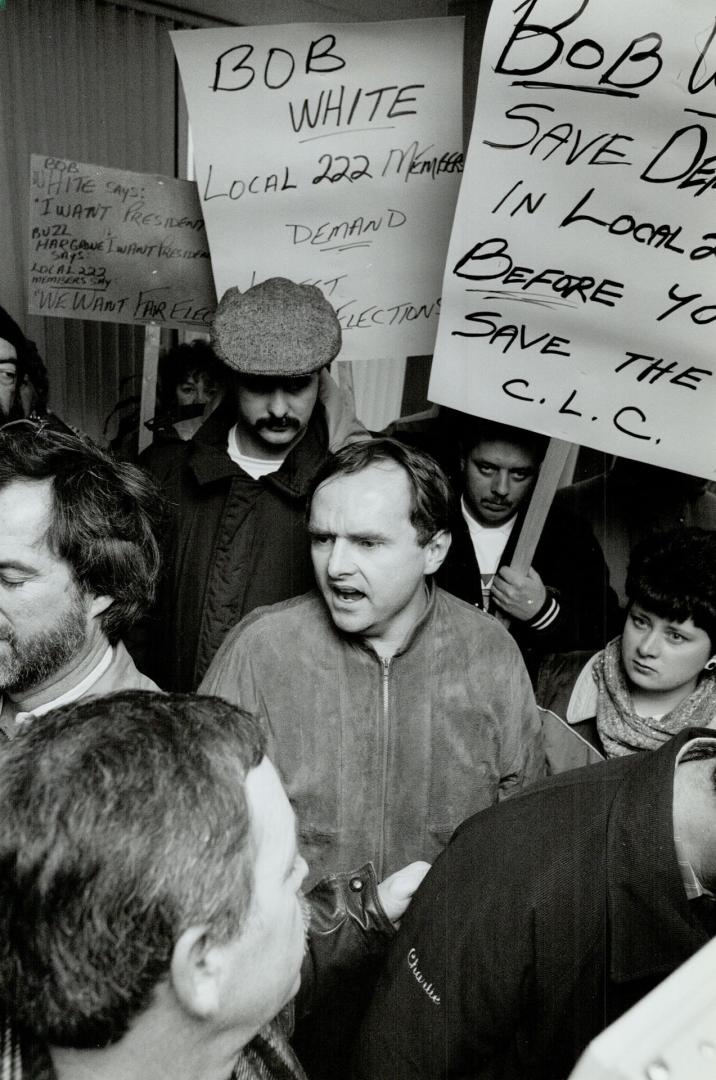 Union row: Canadian Auto Workers official Pat Clancy, left, talks with union members who stormed CAW headquarters this week over bitter election battle