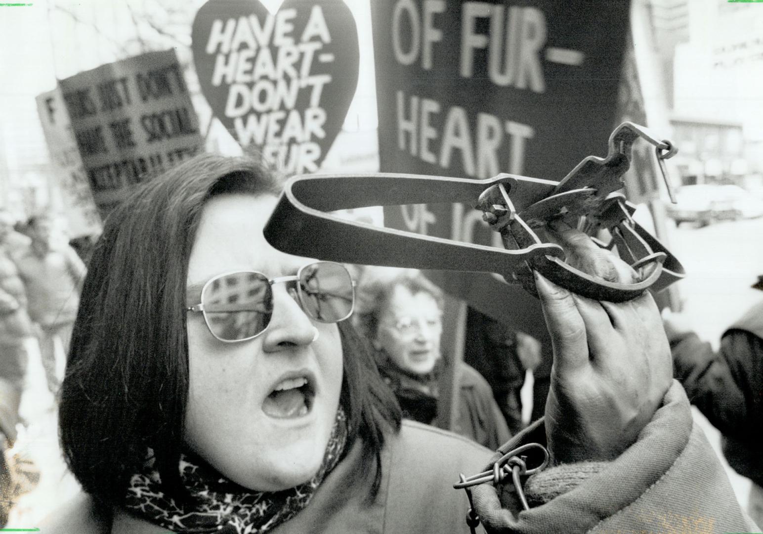 Feeling no pain, Jennifer Collins of Toronto uses an artificial hand and a real leghold trap to focus people's attention during a sidewalk demonstrati(...)