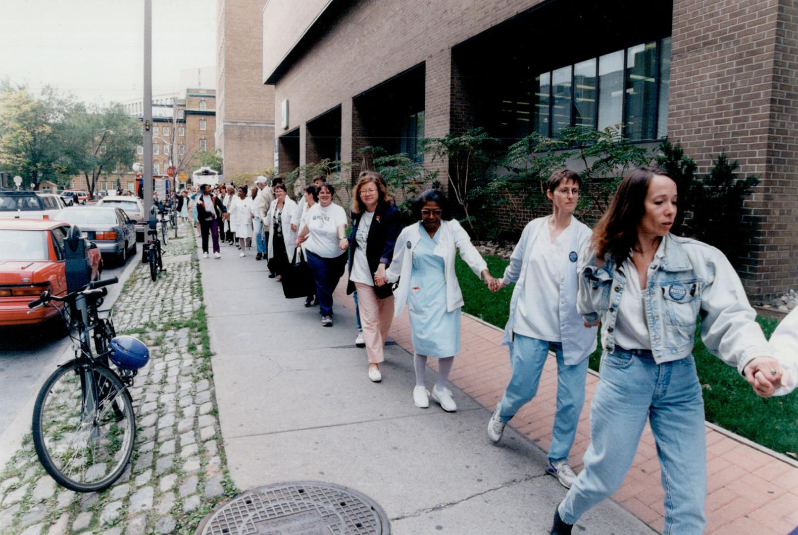 Linked arms round Women's College Hospital