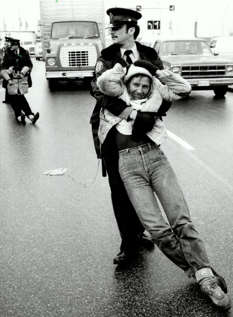 What a drag: This anti-nuke protester at the Etobicoke Litton Systems plant had to be dragged off the road by police yesterday when she tried to block traffic by lying in the street