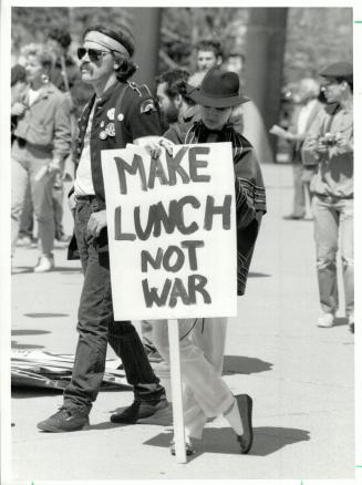 Tasteful protest: The sign carried by this demonstrator in yesterday's 5th annual spring protest for peace, organized by the group ACT for Disarmament, touted a tasty alternative to war