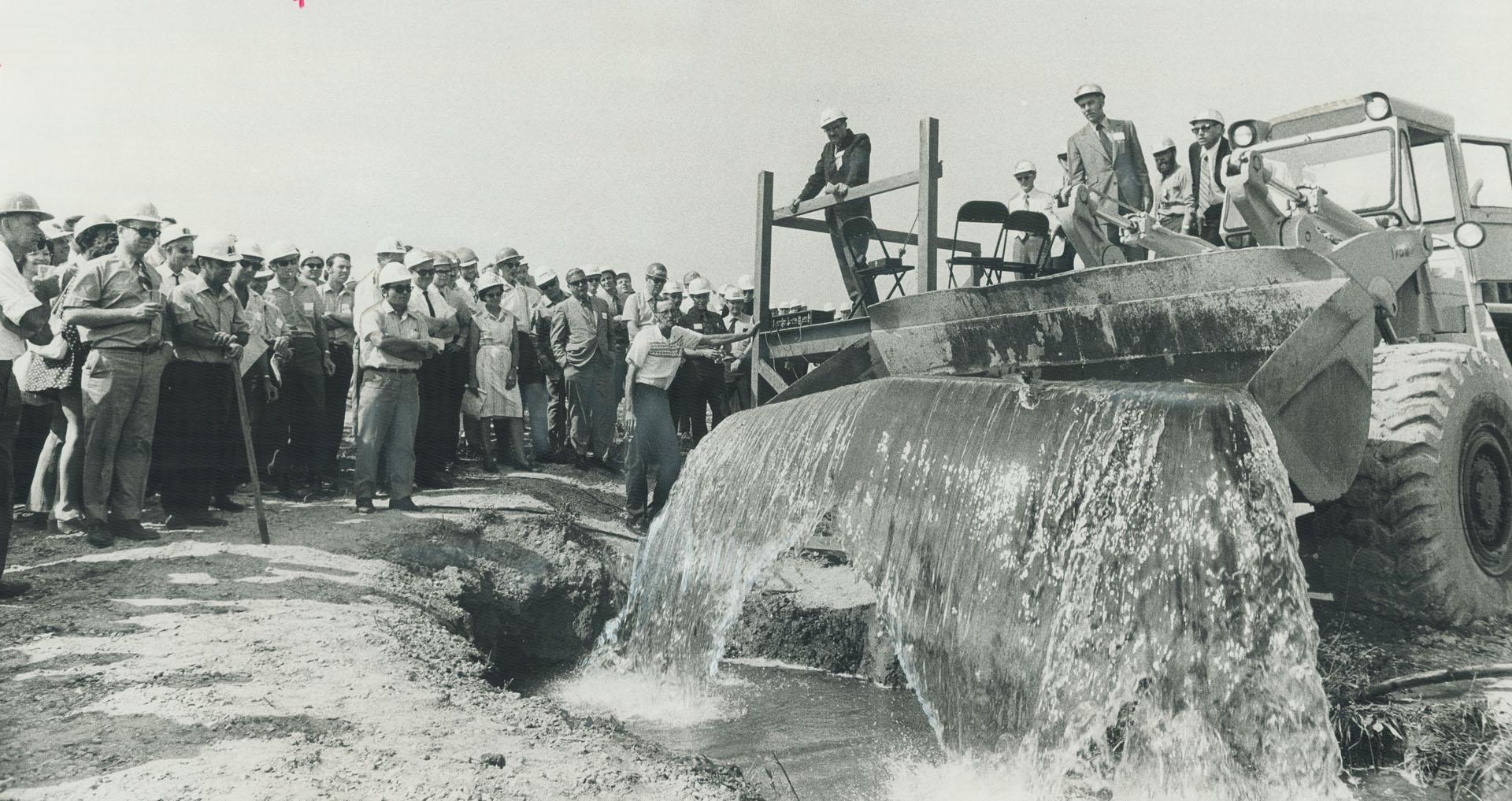 Gravel firm has trout by the bucketfull, Front-end loader is used to stock a new man-made lake on the property of Consolidated Sand and Gravel Co. nea(...)