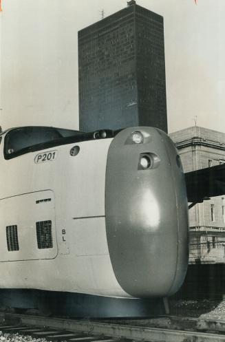 The Tortoise in the race between Star travel writers Gerry Hall and George Bryant from Toronto to Montreal was the world's first turbo train, silhouetted against the towering Toronto-Dominion Centre