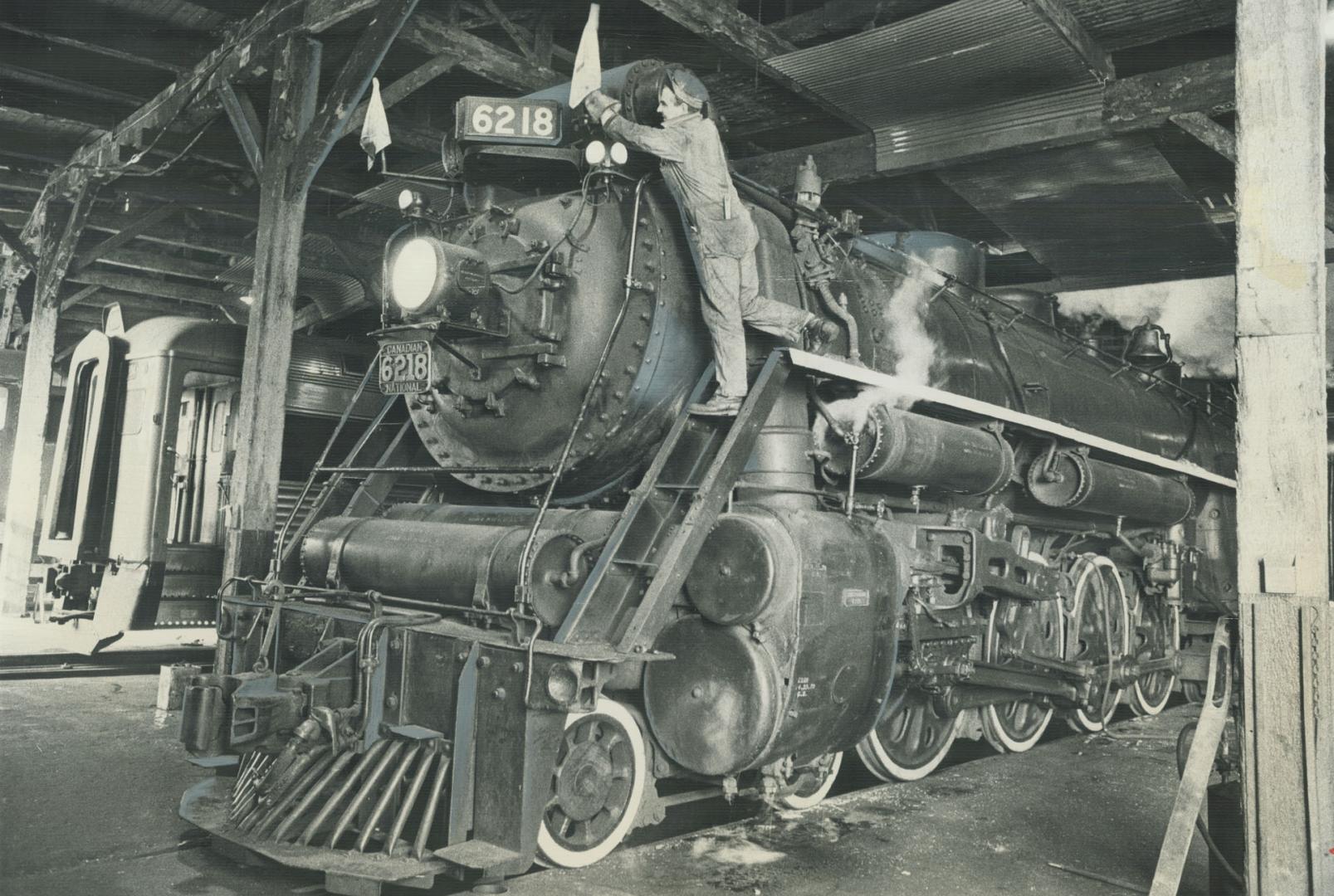 Adjusting the Flag on Canada's last operating steam locomotive, machinist Matt Konuck prepares the old engine for what may be its last run. The locomo(...)