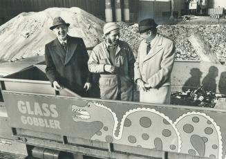 Three men in the truck are pointing to the name on the side, Glass Gobbler, which defines its job