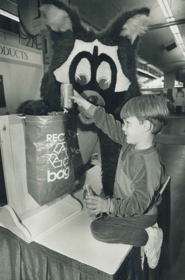 Can it: Patrick Slike, 5, and a furry friend test a bag for recyclables at an Exhibition Place showcase of products described as environmentally inoffensive