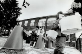 Students at Nativity of Our Lord School feed front yard composters with lunchtime leftovers