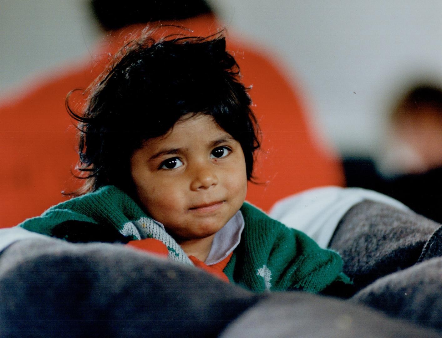 Her home's a cot, A little Albanian girl sits on a cot supplied by the army in a camp outside the Italian port of Brindisi. About 20,000 Albanians see(...)