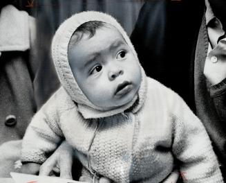 A tiny refugee arrives, A Chilean baby whose family has fled to Canada waits at Toronto International Airport last night while adults are processed by(...)