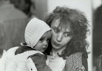 Finding sanctuary: Bosnian refugees Ranza Kadic and baby Amir wait to be processed by immigration officials at Pearson International Airport last night before making connector flight to Winnipeg