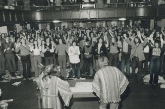 Youngsters sing and pray at an evangelistic musical service in Cody Hall at St