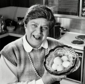 Rites of Passover: Above, Sandra Ruben Temes holds a basket of hard-boiled eggs - symbols in the Passover Seder ceremony