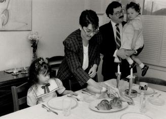 Sholom and Rifka Eisenstat prepare to celebrate the Sabbath with their children Yedida, 5 1/2, and Ayala, 2