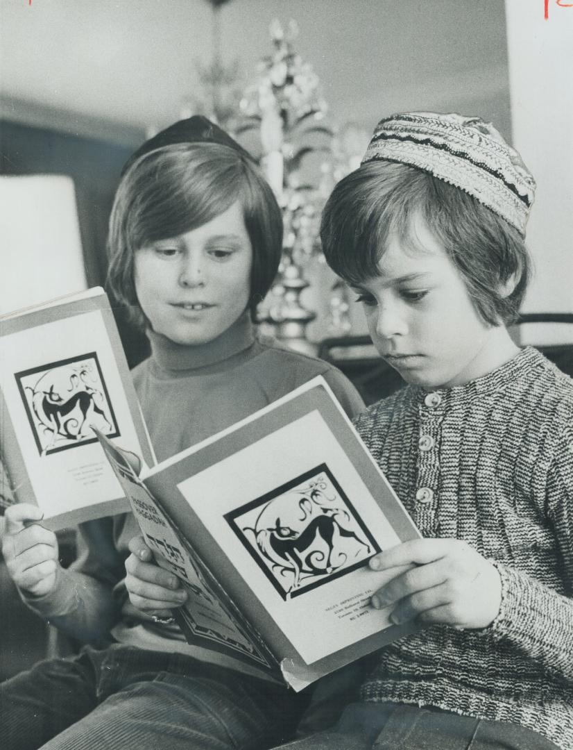 The passover ritual is studied by Stephen Green, 11, (left) and his brother Evan, 8, who will ask the traditional questions tonight at the family's o(...)