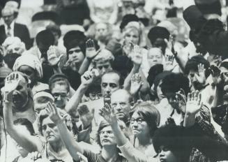 Worshippers Raise their hands handing the new life crussade in Varsity arena in June