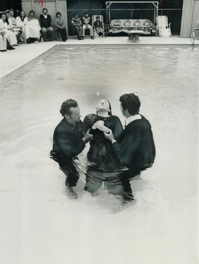 Harry Spencer of Petrie Way, Clarkson, and Read Myer, pastor of the Lakeview Alliance Tabernacle, baptize 12-year-old Rosalea Wiscombe yesterday in Sp(...)