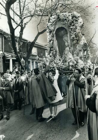 Santo Cristo Procession, with bearers carrying a life-size statue of Christ, moves along Toronto street yesterday in fifth annual festival sponsored b(...)