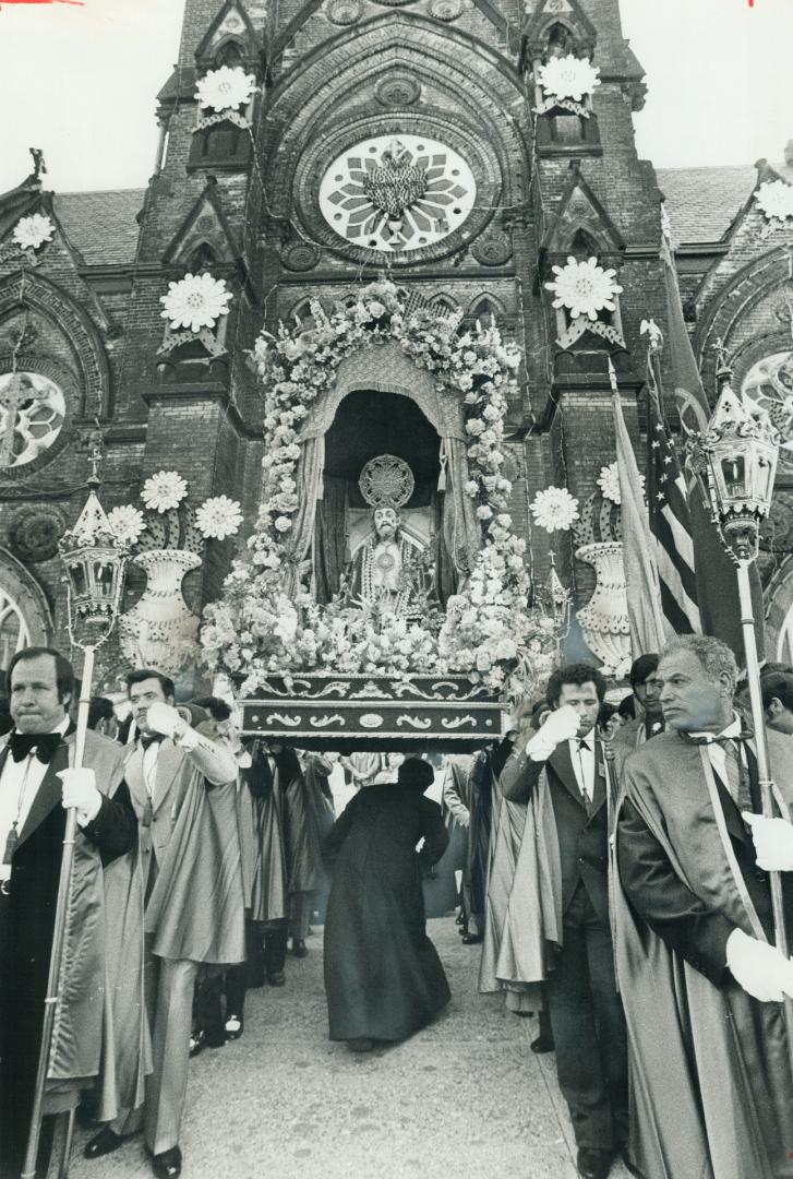 With 100,000 people watching the procession of Santo Cristo leave St