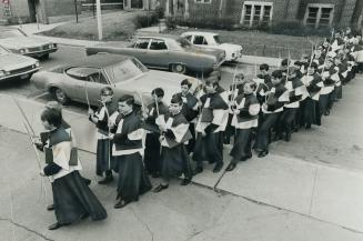 Metro Solemnly Marks Palm Sunday, Bearing palm leaves, the choir boys of St