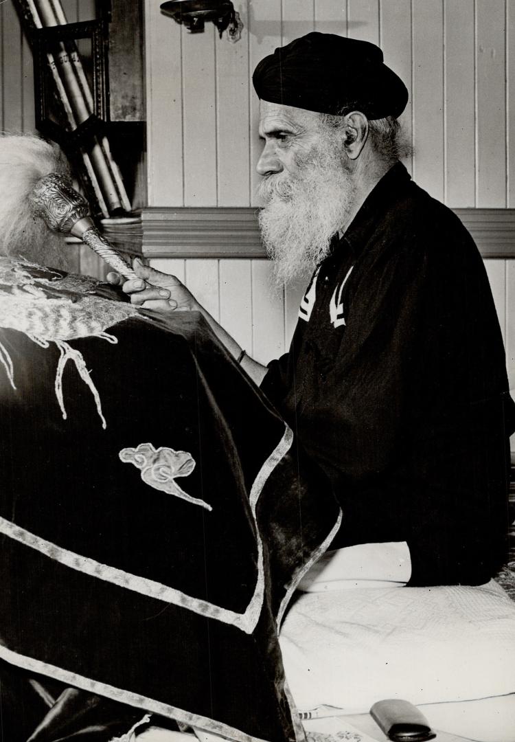 Right, the priest, as he reads the Sikh scriptures, fans the sacred text to keep pests away