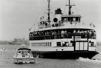 Forced exit: A ferry loaded with hooky-playing teenagers leaves Centre Island yesterday escorted by a police launch