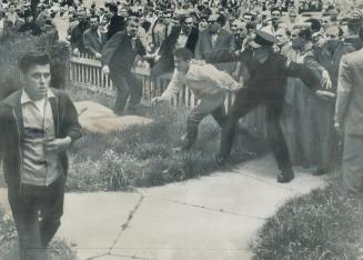 Surging Mob Attempts To Push Past Policeman To Get At Yves Moreau (left) In yesterday's Allan Garden Riot, Ignac David (centre, in light jacket) was o(...)