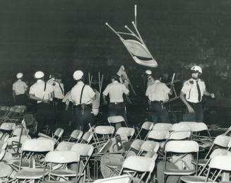 The riot: A chair flies during the uproar after Alice Cooper failed to appear at the CNE Tuesday night