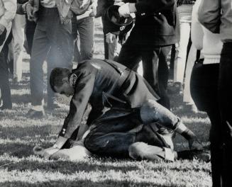 Policeman pins student after his hat was knocked off, Hundreds in melee tried to prevent police from arresting friends