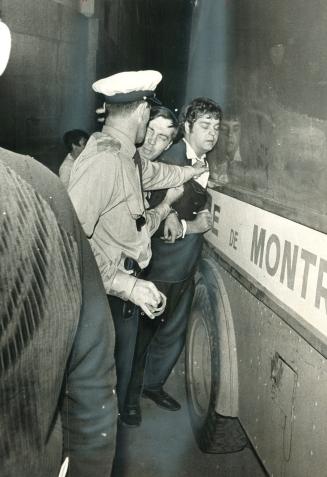 Montreal rioter is pushed against one of the estimated 10 paddy wagons the police had along the parade in anticipation there would be violence last night