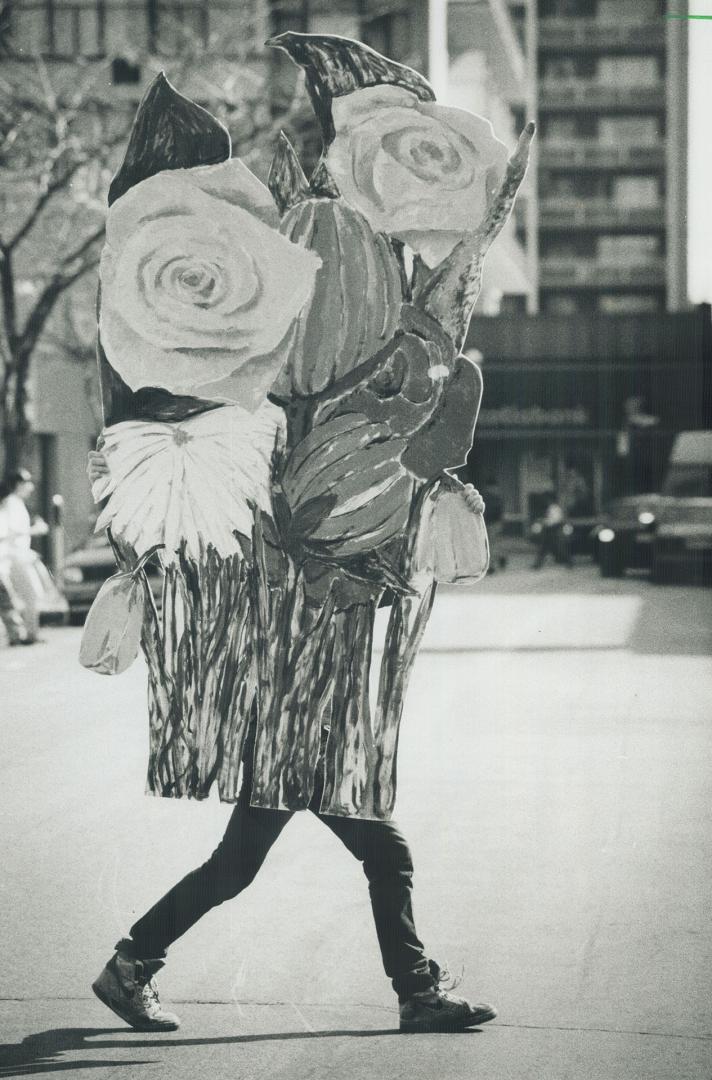 Spring is definitely in the air, So Joel Wasson takes advantage of the warm, dry weather yesterday to move a panel of flowers, which had been on displ(...)