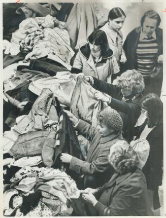 Bargain hunters lose themselves in piles of merchandise at annual Hadassah Bazaar yesterday