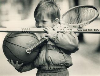 Tennis anyone? Well what about hockey? Basketball? Christopher George, 3, loads up with sports gear at yesterday's 11-floor garage sale at Women's Col(...)