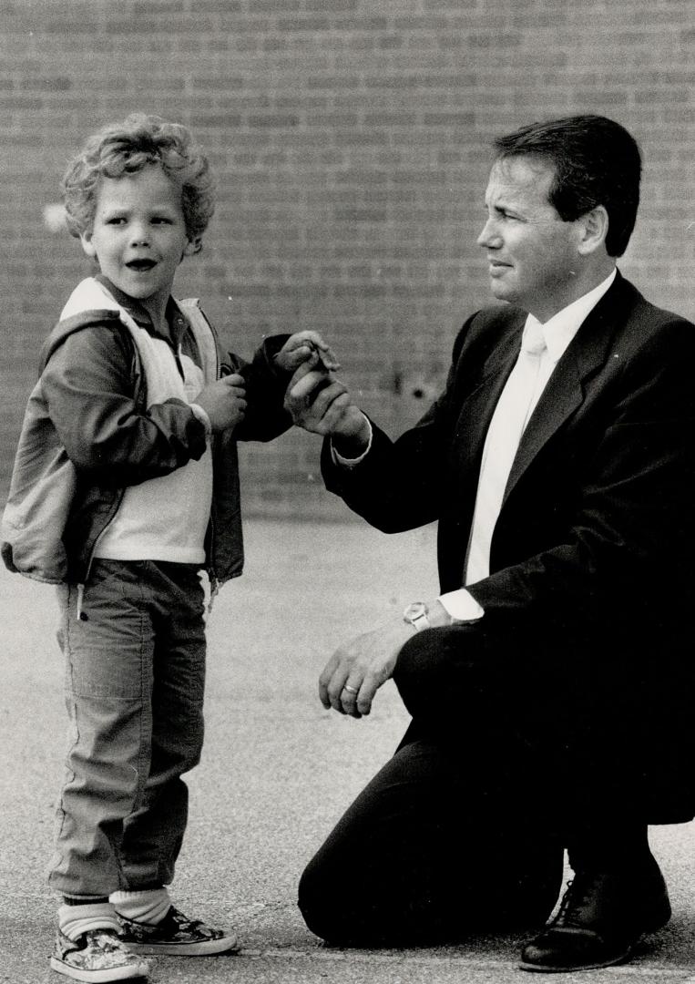 Communicating: Ernest C. Drury School superintendent Paul Bartu checks out Andrew Wilson, 5, in the schoolyard while Linda McLaughlin teaches her Grade 1 class