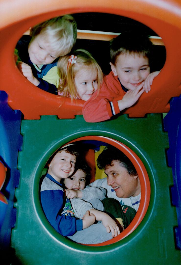 Peek-a-boo!, Myrna Macey (bottom right), supervisor of the King City Nursery School gets rightinto the spirit of play ith some of the 42 children at t(...)