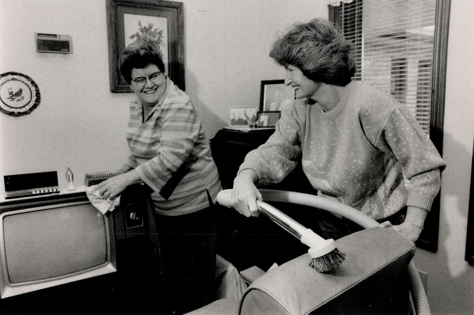 Home Help: Tina Favro (left) gets a hand with the housework from Linda Wilton-Rudall, who helps Favro look after her home and housebound husband