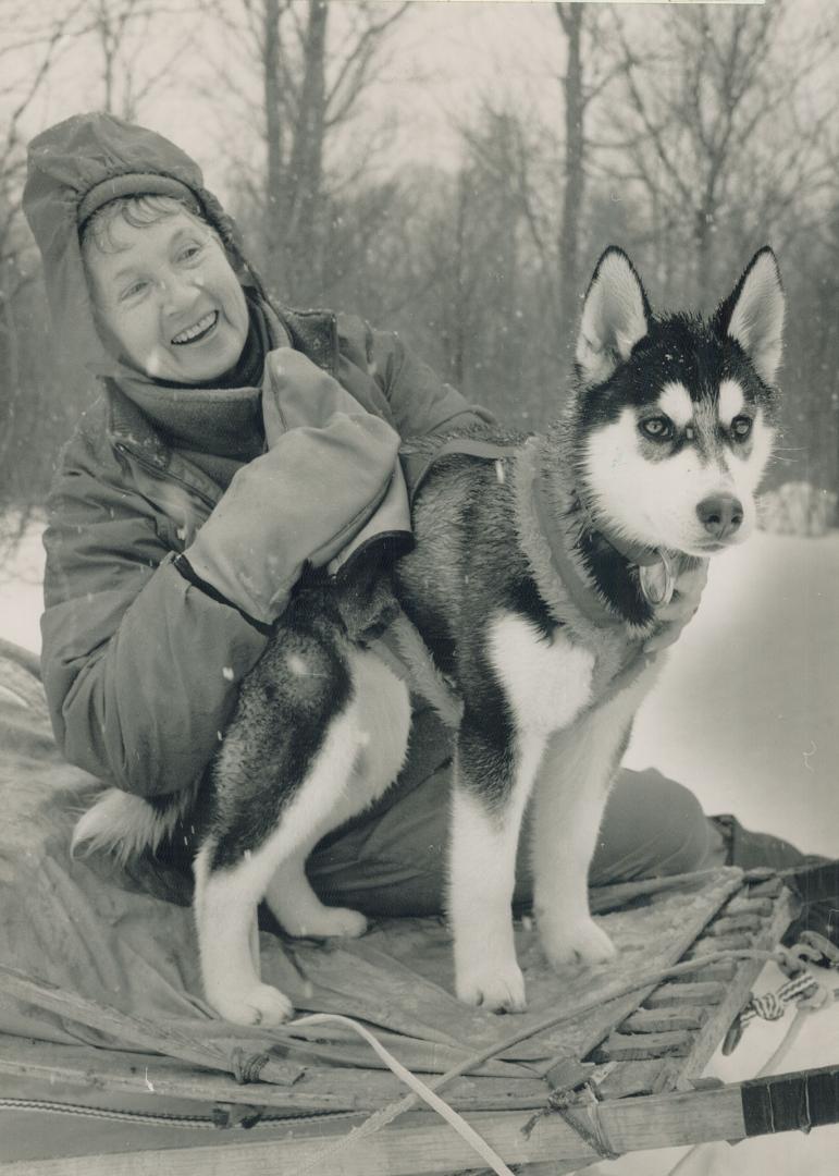 New friend: Jean Johnson makes friends with a young huskie