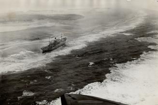 The latest victim of the treacherous sands of Sable Island, long famous as the graveyard of the Atlantic, the Greek freighter Alfios is seen firmly ag(...)