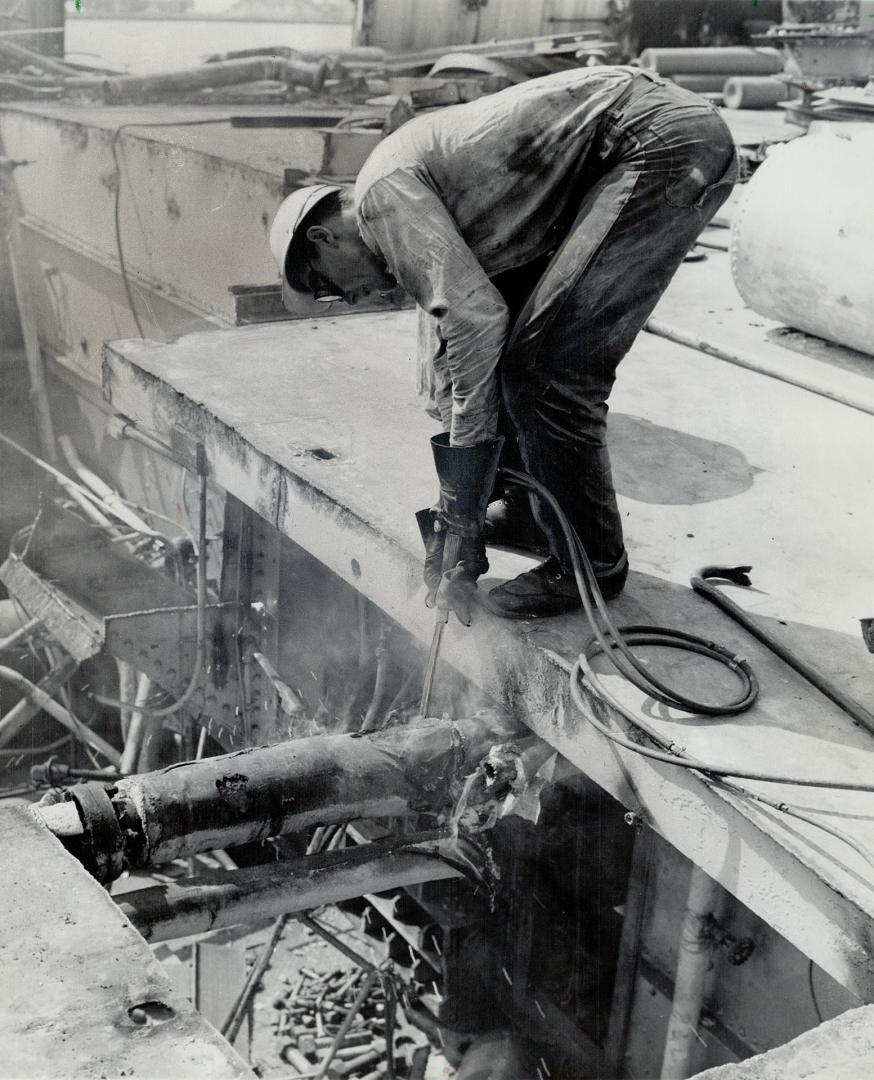 Torch bites into the 2,196-ton ship during demolition