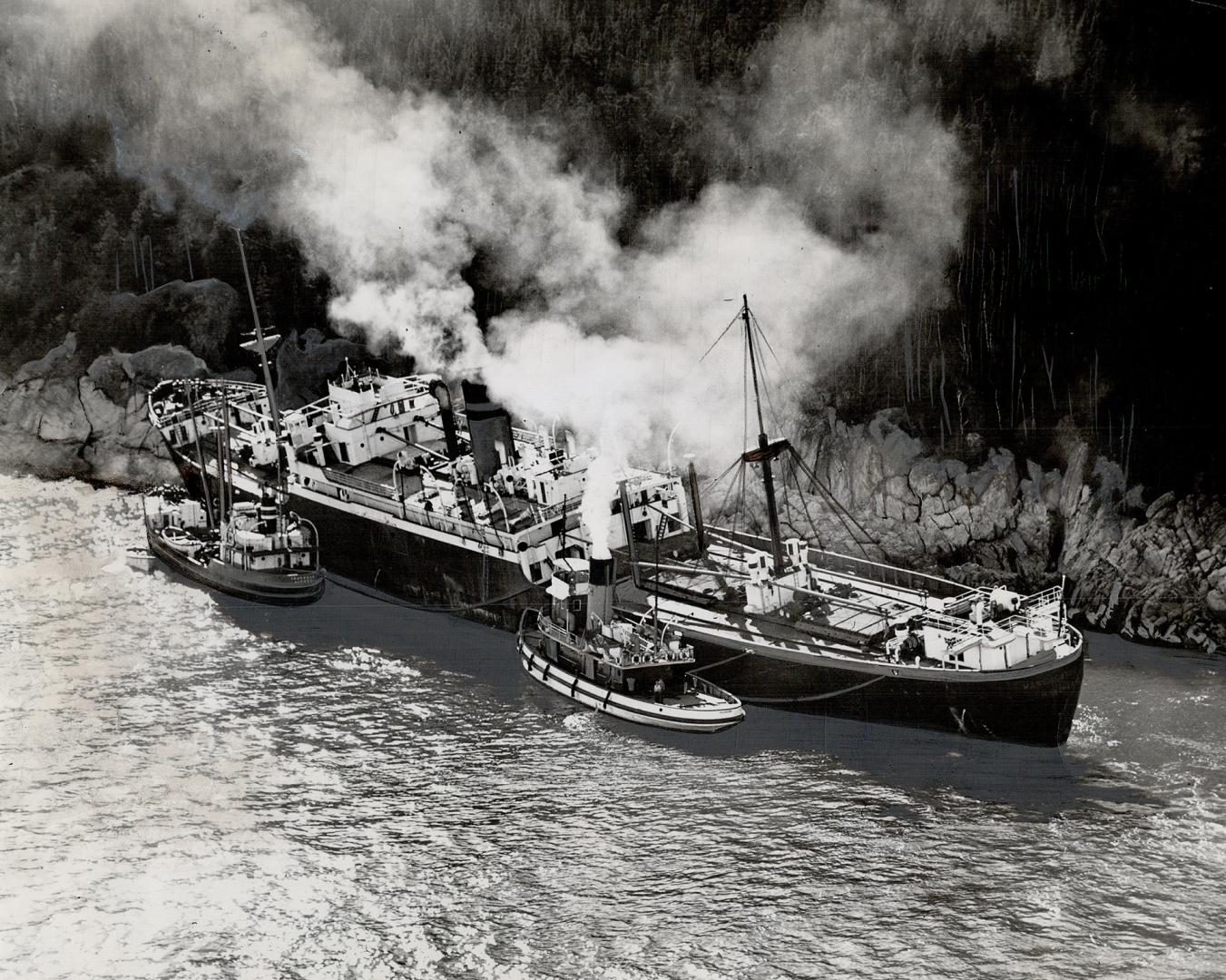 High on the rocks in the St. Lawrence, 92 miles below Quebec City, the liner Manchester City will be pulled off the rocks by salvage tugs, it is expec(...)