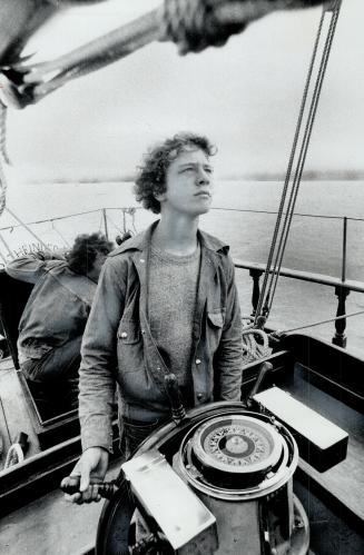 At the helm, Watch Officer Stan Bydal, 18, of Toronto steers the Pathfinder, a sail-training brigantine that's been cruising the Great lakes for 10 year now