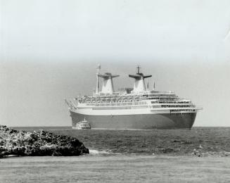 At top a fashion show around the ship's pool, above left the Norway awaiting passengers off a Bahamas isle and at left one of its destinations, St. Maarten