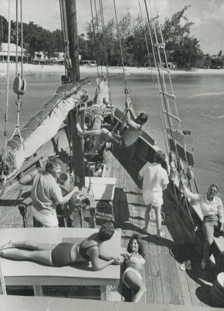 Aboard a cruise boat off a Barbados beach, this group of tourists enjoys an afternoon's sail in calm, clear waters, another major attraction of the Ca(...)